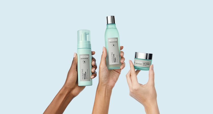 Three hands holding up ARTISTRY SKIN NUTRITION Hydrating Solution products against a blue background 
