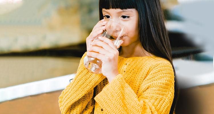 Girl drinking a glass of water 